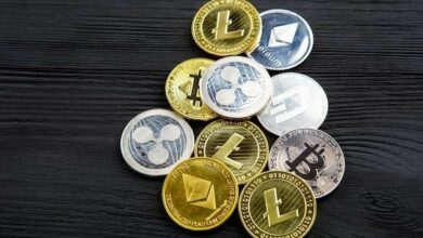 Several crypto coins on a wooden background